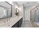 Bathroom features double vanity with dark cabinets, a glass door shower, and modern finishes throughout at 85 Willow Bend Dr, Youngsville, NC 27596
