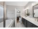 Bathroom with a separate soaking tub, double sink vanity, and an open doorway to the bedroom at 85 Willow Bend Dr, Youngsville, NC 27596