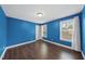 Blue bedroom with two windows and hardwood floors at 85 Willow Bend Dr, Youngsville, NC 27596