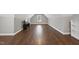 Spacious bonus room with wood flooring, TV, and natural light from two windows at 85 Willow Bend Dr, Youngsville, NC 27596