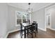 Dining room features wood floors, modern lighting, and abundant natural light from the surrounding windows at 85 Willow Bend Dr, Youngsville, NC 27596