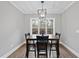Dining room with hardwood floors, modern lighting fixture, and lots of natural light from large windows at 85 Willow Bend Dr, Youngsville, NC 27596