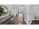 Inviting entryway featuring gleaming hardwood floors and a stylish console table with decorative accents at 85 Willow Bend Dr, Youngsville, NC 27596