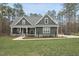 Inviting home exterior with stone accents, landscaped yard, and covered porch, ready to welcome you at 85 Willow Bend Dr, Youngsville, NC 27596