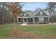 Charming home showcasing a well-manicured front yard and inviting entrance with rocking chairs at 85 Willow Bend Dr, Youngsville, NC 27596