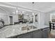 Spacious kitchen with granite countertops, stainless steel appliances, and open view to the living room at 85 Willow Bend Dr, Youngsville, NC 27596