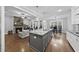 Island in an open-concept kitchen and living area with stylish pendant lighting and stainless sink at 85 Willow Bend Dr, Youngsville, NC 27596