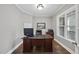 Bright office with a large desk, hardwood floors, crown molding, and natural light from a large window at 85 Willow Bend Dr, Youngsville, NC 27596