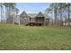 Back exterior view shows the screened porch and deck and the beautiful green lawn at 85 Willow Bend Dr, Youngsville, NC 27596