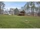 Back exterior view shows the screened porch and deck and the beautiful green lawn at 85 Willow Bend Dr, Youngsville, NC 27596