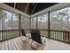 Relaxing screened-in porch with wooden floors, ceiling and a view of the serene, wooded backyard at 85 Willow Bend Dr, Youngsville, NC 27596