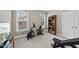 Home gym with exercise equipment, carpet floors, a door, and a window for natural light at 85 Willow Bend Dr, Youngsville, NC 27596