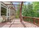 Spacious wooden deck with a pergola, outdoor seating, and lush green surroundings at 101 Tussled Ivy Way, Cary, NC 27513