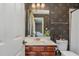 Bathroom with wood vanity, floral wallpaper, and well-lit vanity at 101 Tussled Ivy Way, Cary, NC 27513