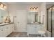 Bathroom with double vanities, walk-in shower, and neutral color scheme at 101 Tussled Ivy Way, Cary, NC 27513