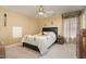 Comfortable bedroom with a ceiling fan, neutral decor, and a cozy atmosphere at 101 Tussled Ivy Way, Cary, NC 27513