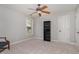 Spacious bedroom with neutral carpet, a ceiling fan, and natural light from the window at 101 Tussled Ivy Way, Cary, NC 27513