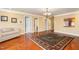 Bonus room with hardwood flooring, access to hallway, and decorative rug at 101 Tussled Ivy Way, Cary, NC 27513