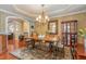 Charming dining area features hardwood floors, an ornate chandelier, decorative accents, and plenty of space for gatherings at 101 Tussled Ivy Way, Cary, NC 27513