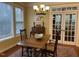 Bright dining area with natural light, decorative chandelier, and traditional furnishings at 101 Tussled Ivy Way, Cary, NC 27513