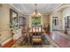 Elegant dining room with tray ceilings, hardwood floors, chandelier lighting, and a spacious table for entertaining at 101 Tussled Ivy Way, Cary, NC 27513