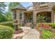 Elegant stone home with a fountain, lush landscaping, and a welcoming entrance at 101 Tussled Ivy Way, Cary, NC 27513