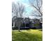 Traditional brick home with well-manicured lawn and landscaping, complemented by mature trees and an attached garage at 101 Tussled Ivy Way, Cary, NC 27513