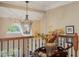 Elegant hallway with decorative chandelier, detailed woodwork, and natural light at 101 Tussled Ivy Way, Cary, NC 27513
