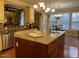 Kitchen island with seating and granite countertops, with natural light and modern finishes at 101 Tussled Ivy Way, Cary, NC 27513