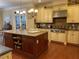 Elegant kitchen with granite counters, island, and stainless steel appliances at 101 Tussled Ivy Way, Cary, NC 27513