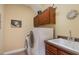 Functional laundry room featuring a washer, dryer, sink, and storage cabinets at 101 Tussled Ivy Way, Cary, NC 27513