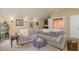 Open living room with a large sectional sofa, wet bar, and natural light at 101 Tussled Ivy Way, Cary, NC 27513