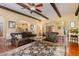 Spacious living area boasts hardwood floors, exposed beams, an open layout, and easy access to the kitchen and dining areas at 101 Tussled Ivy Way, Cary, NC 27513