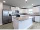 Spacious kitchen features white cabinets, stainless steel appliances, and a granite island at 102 Wilderness Ct, Mebane, NC 27302