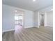Bright, open-concept living space with wood-look floors, offering a view into the kitchen at 102 Wilderness Ct, Mebane, NC 27302
