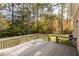 Wooden deck overlooking a lush backyard with mature trees and well-maintained lawn at 1021 Reaves Dr, Chapel Hill, NC 27516