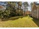 Expansive backyard with a well-manicured lawn and lush trees at 1021 Reaves Dr, Chapel Hill, NC 27516