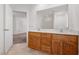 Bathroom featuring a double sink vanity with wooden cabinets and a large mirror at 1021 Reaves Dr, Chapel Hill, NC 27516