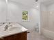 Bright bathroom with double sinks, tile flooring, and a window overlooking nature at 1021 Reaves Dr, Chapel Hill, NC 27516