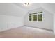Bedroom with dormer window and wall to wall carpeting at 1021 Reaves Dr, Chapel Hill, NC 27516