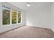 Neutral bedroom with large window revealing a picturesque fall foliage view at 1021 Reaves Dr, Chapel Hill, NC 27516