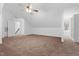 Spacious bonus room with neutral carpet, ceiling fan, and natural light at 1021 Reaves Dr, Chapel Hill, NC 27516
