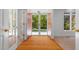 Welcoming entryway with hardwood floors and double front doors opening to a bright, tree-filled view at 1021 Reaves Dr, Chapel Hill, NC 27516