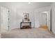 Bright hallway with neutral carpet, white trim, and console table at 1021 Reaves Dr, Chapel Hill, NC 27516