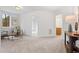 Hallway with wood table and carpet floors. Neutral walls and large window providing natural light at 1021 Reaves Dr, Chapel Hill, NC 27516