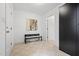 Bright hallway with neutral decor, art, bench, and access to multiple rooms and closet at 1021 Reaves Dr, Chapel Hill, NC 27516