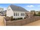 View of the home's rear exterior featuring a fenced backyard with an open pergola and a well-maintained lawn at 1024 Traditions Ridge Dr, Wake Forest, NC 27587