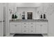 Bathroom featuring double sinks, granite countertops, decorative accents, and large mirror at 1024 Traditions Ridge Dr, Wake Forest, NC 27587