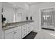 Bright bathroom featuring double sinks, granite countertops, decorative accents, and glass enclosed shower at 1024 Traditions Ridge Dr, Wake Forest, NC 27587