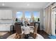 Dining area features seating for four around a glass table and natural light from windows at 1024 Traditions Ridge Dr, Wake Forest, NC 27587